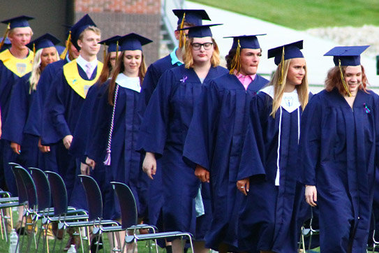 Graduating seniors line up to receive their diplomas.
